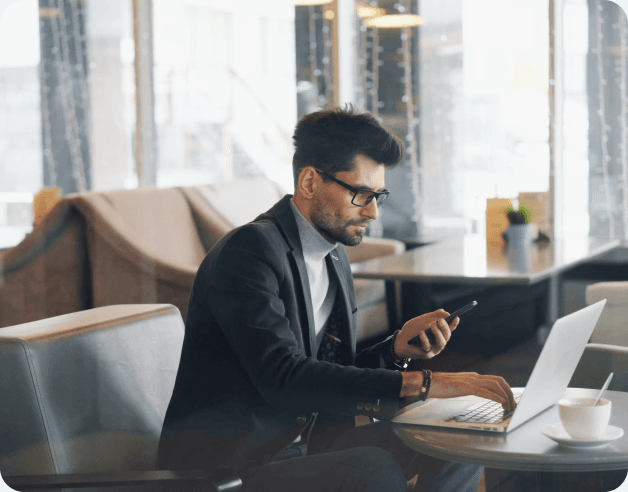 A real estate agent working on a laptop in a modern office